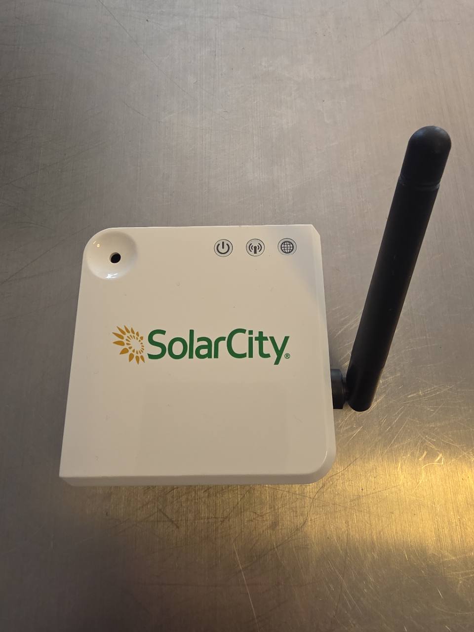 Original white SolarCity monitoring collector with an external black radio antenna